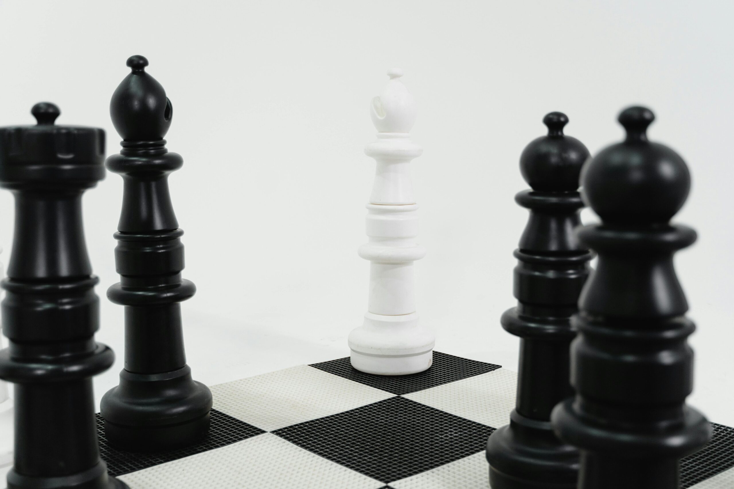 Close-up of chess pieces in strategic formation on a chessboard representing strategic thinking.